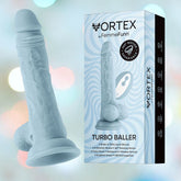 A light blue adult toy with a realistic design stands upright on a base, next to its packaging. The box displays the product name "Femme Funn Wireless Turbo Baller" by Femme Funn and highlights features such as 100% liquid silicone, 360-degree rotating motion, and 8 vibration modes.